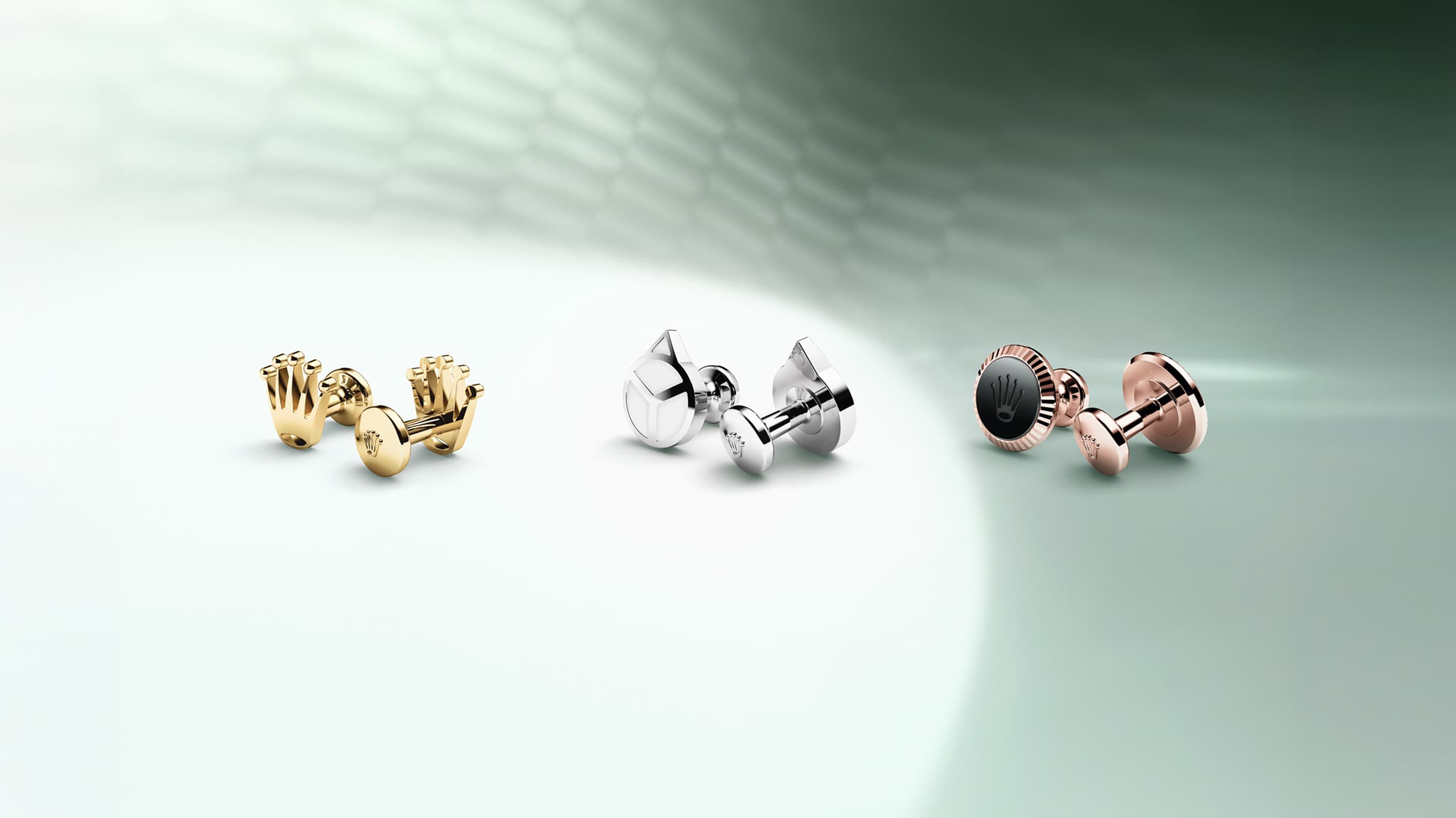 Three pairs of Rolex cufflinks shown from left to right: Rolex 'Crown' cufflinks in 18 ct yellow gold; Rolex 'Hand' cufflinks in white gold; Rolex 'Fluted' cufflinks in Everose gold. - DAFC