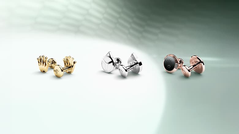 Three pairs of Rolex cufflinks shown from left to right: Rolex 'Crown' cufflinks in 18 ct yellow gold; Rolex 'Hand' cufflinks in white gold; Rolex 'Fluted' cufflinks in Everose gold. - DAFC
