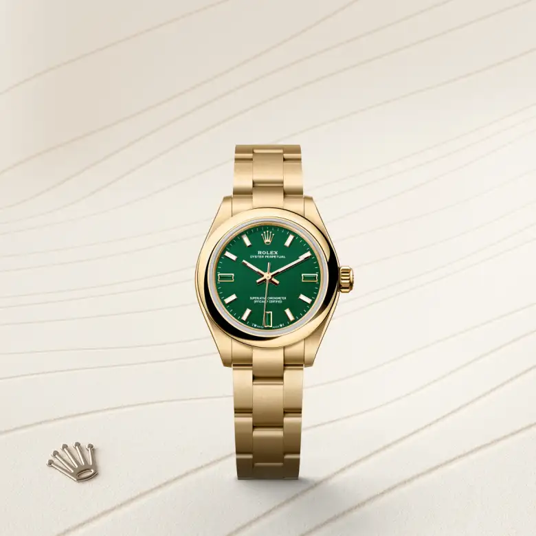The Rolex Oyster Perpetual 28 in yellow gold shown against a muted elegant background.