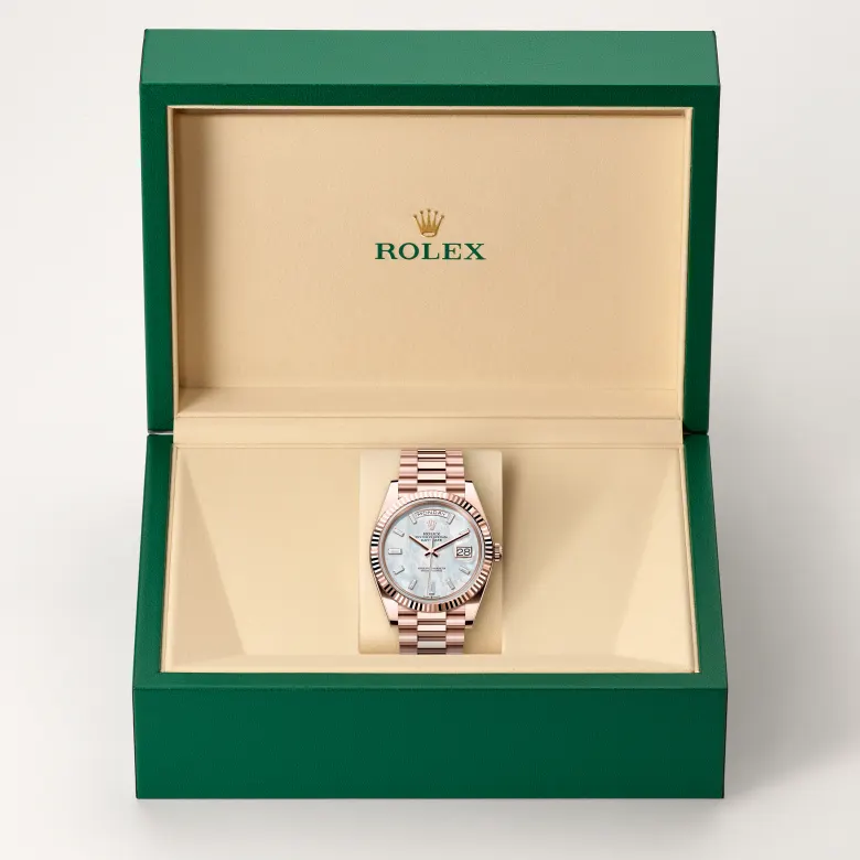 The Rolex Day-Date 40 in Everose gold in the Rolex presentation box.
